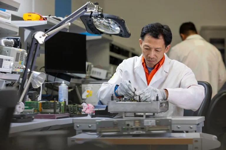 Alstom repair technician repairing a fault circuit board in an in house repair lab
